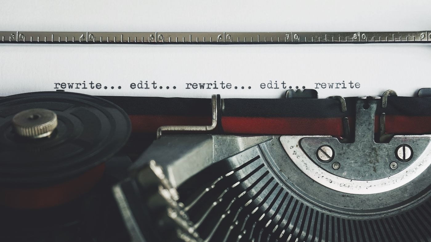 A typewriter page carries the words rewrite and edit.