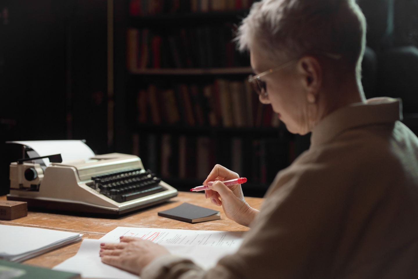 Reader considering a printed script beside a typewriter