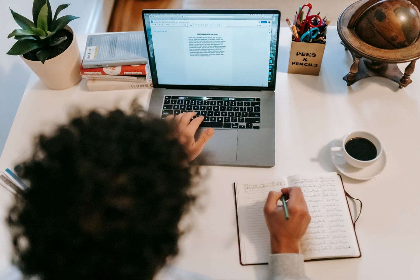 Writer working with a laptop and notebook