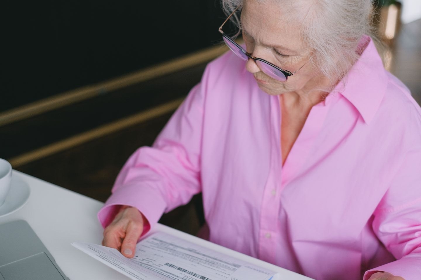 Reader studying several printed documents