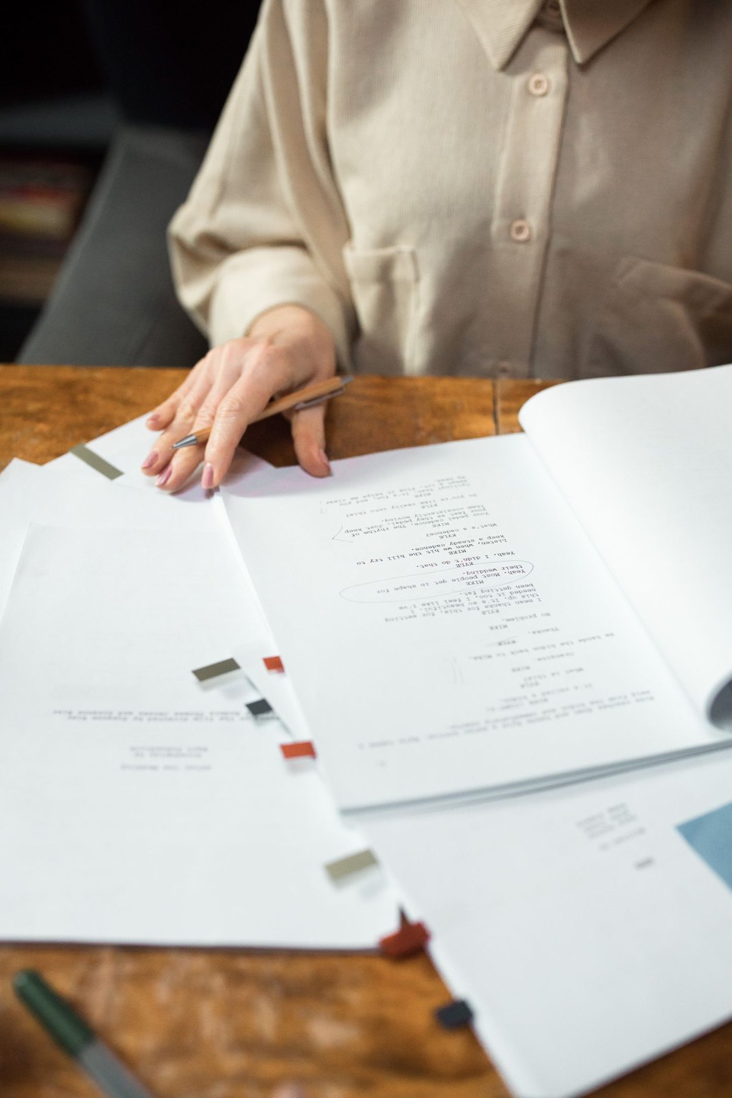 Hands handling a set of manuscript pages